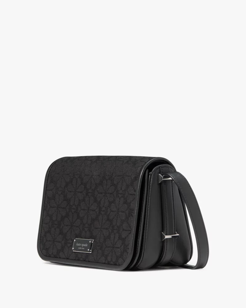 bolsa transversal liv spade com estampa floral em jacquard preta e multicolorida.